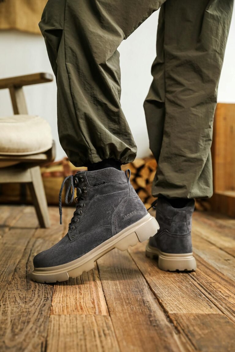 Fashionable boots with casual pants in a cozy indoor setting.